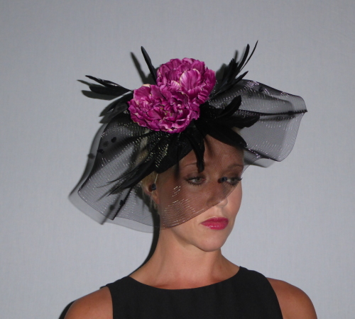 A flurry of Black Crin set on a teardrop base, elastic band to match hair colour and adorned with Black Biot feathers and a deep Pink Peony.