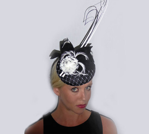 Black Sinamay button covered in White Veiling with White & Black flower, leaves & Black & White Quills.