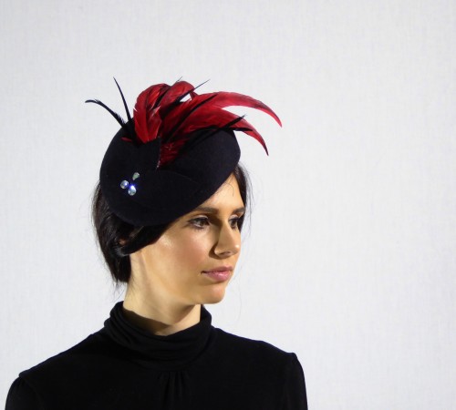 Military style beret in black with red feathers and diamante detail.
